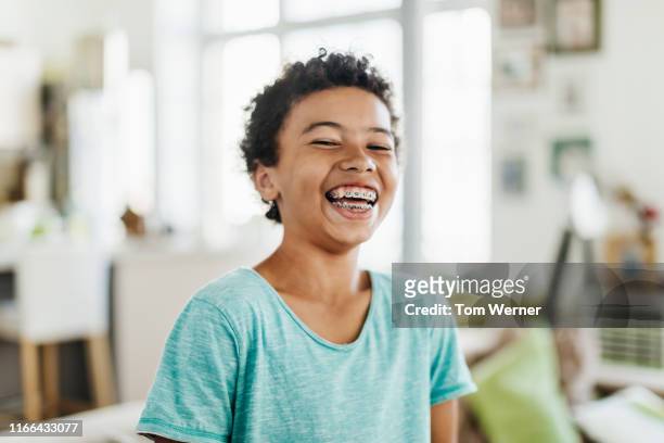 portrait of young boy smiling - braces and smiles fotografías e imágenes de stock