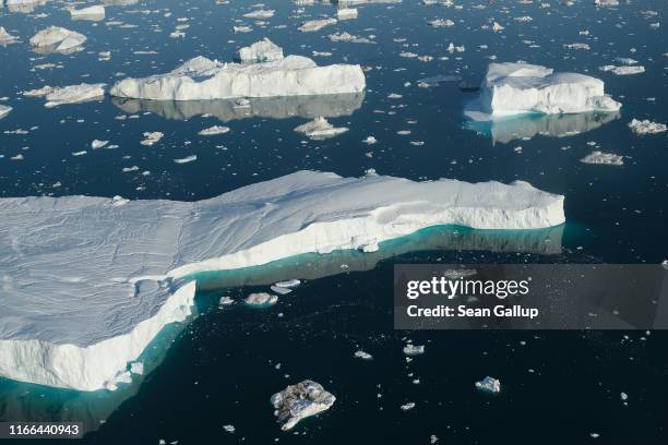 In this view from an airplane icebergs float at the mouth of the Ilulissat Icefjord on August 04, 2019 near Ilulissat, Greenland. The Sahara heat...