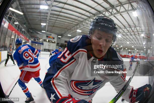 Tyler Angle of the Columbus Blue Jackets is checked into the boards during Day-1 of the NHL Prospects Tournament against the New York Rangers at...