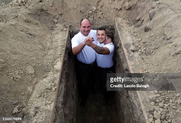 Gravediggers, Robert Szakaly and Rudolf Kecskemeti celebrate after winnig the 4th Hungarian grave digging championship on September 7, 2019 in...