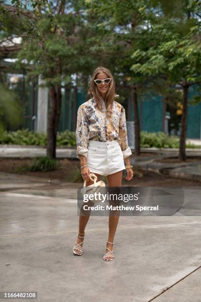 Guest is seen on the street during Copenhagen Fashion Week SS20 wearing colorful pattern shirt, white shorts, sunglasses on August 06, 2019 in...