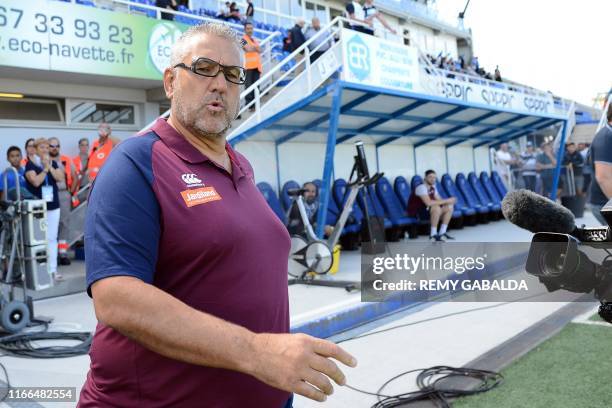 Bordeaux-Begles' head coach Christophe Urios arrives on the pitch prior to the French Top 14 rugby union match between Castres and Bordeaux-Begles,...