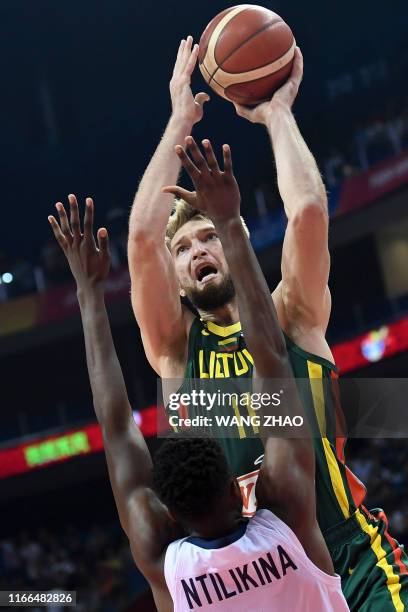 Lithuania's Domantas Sabonis takes a shot as France's Frank Ntilikina tries to block during the Basketball World Cup Group L second round game...