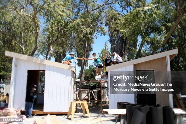 Volunteers with Habitat for Humanity build emergency housing units in San Jose, Calif., for a future homeless transitional community on Friday, Aug....