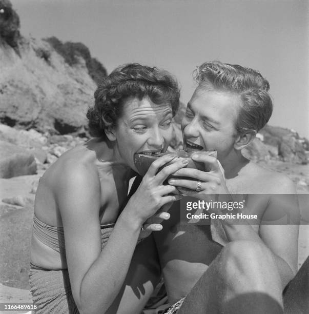 American jazz musician Mel Tormé enjoys a picnic on the beach with his wife, actress Candy Toxton , USA, circa 1950. The two were married in February...