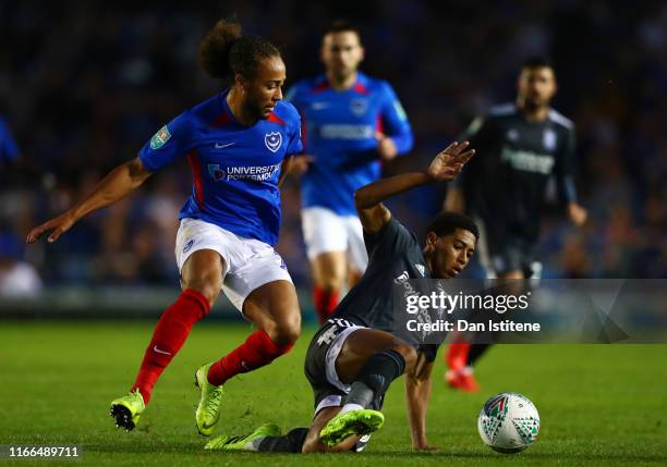 Marcus Harness of Portsmouth battles for the ball with Jude Bellingham of Birmingham City during the Carabao Cup First Round match between Portsmouth...