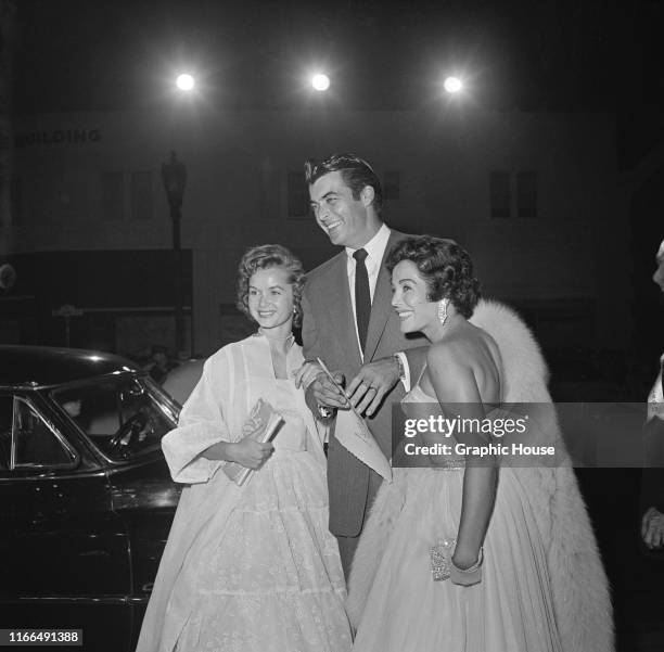 American actor Rory Calhoun poses with his wife, actress Lita Baron and actress Debbie Reynolds at a premiere in Beverly Hills, California, circa...