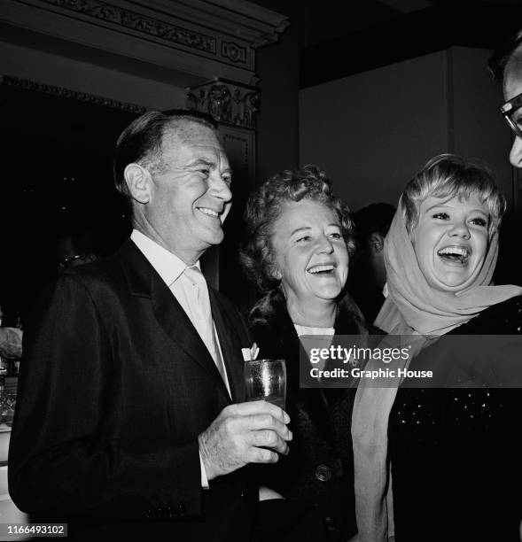 From left to right, English actor Sir John Mills with his wife, actress Mary Hayley Bell and their daughter, actress Hayley Mills at a lunch hosted...