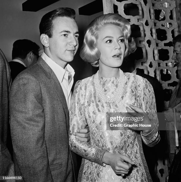 American singer and actor Bobby Darin with his wife, actress Sandra Dee at a lunch hosted by producer Ross Hunter, USA, 1964.