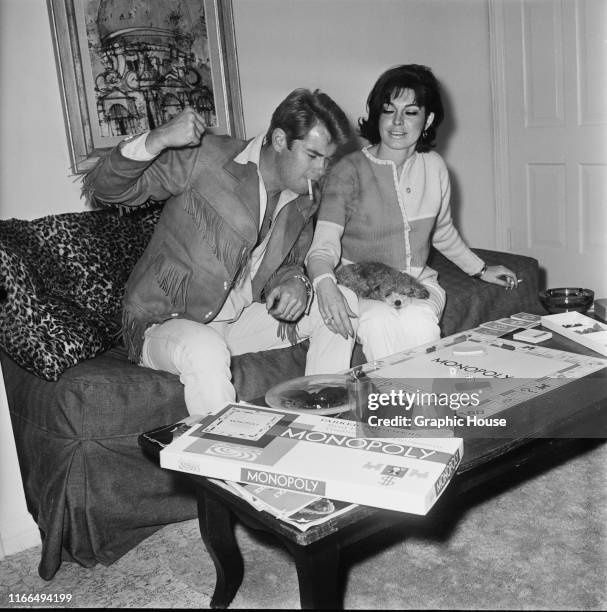 American actor Troy Donahue playing Monopoly at home in Beverly Hills, California, with his wife Valerie Allen, circa 1967.