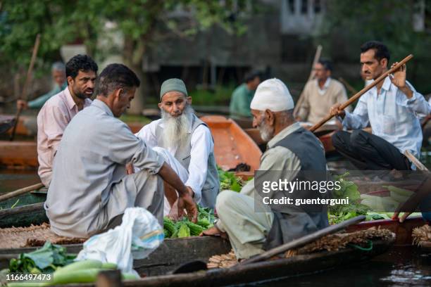 farmer selling vegetables on floating market, srinagar, kashmir, india - jammu and kashmir stock pictures, royalty-free photos & images