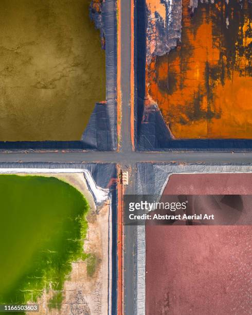 Four tailing ponds at a gas plant as seen from directly above, Western Australia