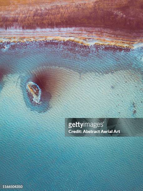 aerial perspective at the edge of a vibrant coloured salt pool, western australia - extreme terrain stock pictures, royalty-free photos & images