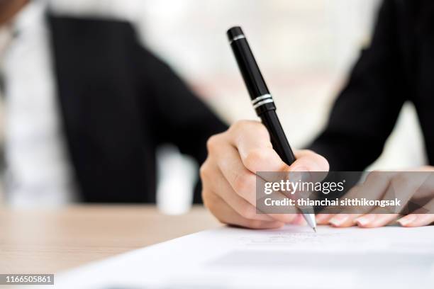 business woman signing a contract - form filling fotografías e imágenes de stock