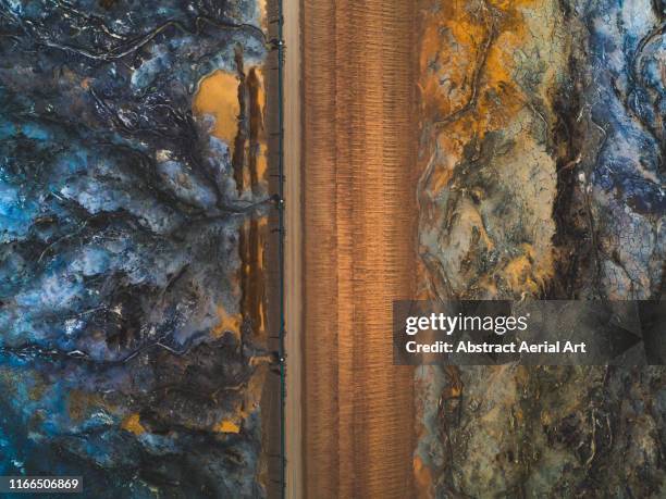 dirt road between mine tailings as seen from above, kalgoorlie, australia - kalgoorlie stock pictures, royalty-free photos & images