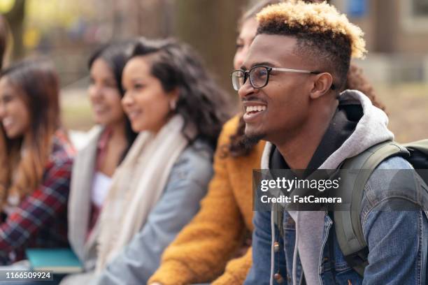 multi-ethnic group of university students relaxing outside - management student stock pictures, royalty-free photos & images