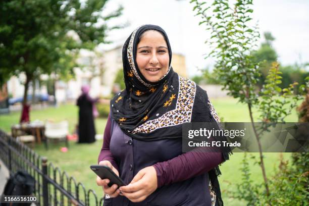 islam syrian woman using mobile portrait - syrie stock pictures, royalty-free photos & images