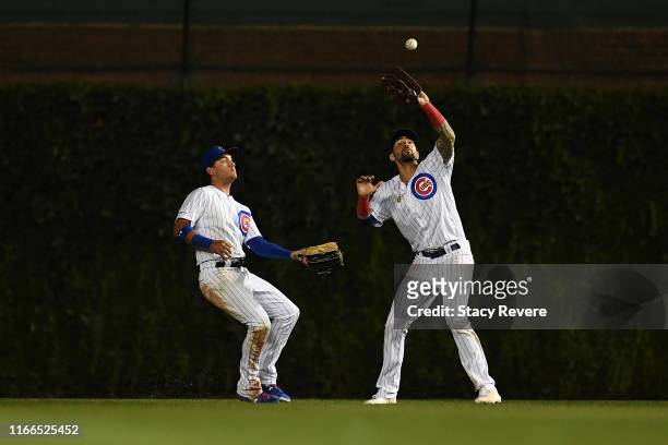 Nicholas Castellanos of the Chicago Cubs fields a fly ball as teammate Albert Almora, Jr. #5 backs up the play during the ninth inning against the...