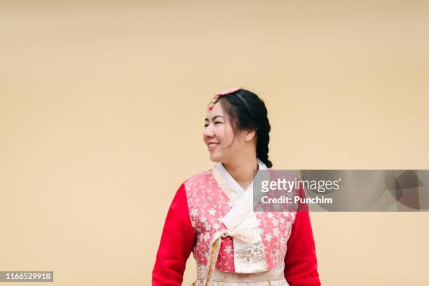 asian woman dressed hanbok pose of standing in seoul, south korea - korean stock pictures, royalty-free photos & images