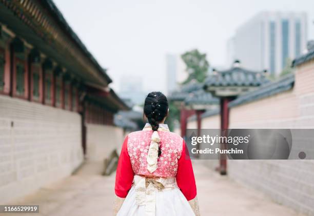 asian woman dressed hanbok pose of standing in seoul, south korea - hanbok stock pictures, royalty-free photos & images