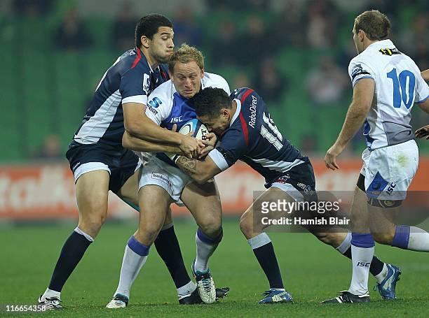 Brett Sheehan of the Force is tackled by Mark Gerrard and Richard Kingi of the Rebels during the round 18 Super Rugby match between the Rebels and...