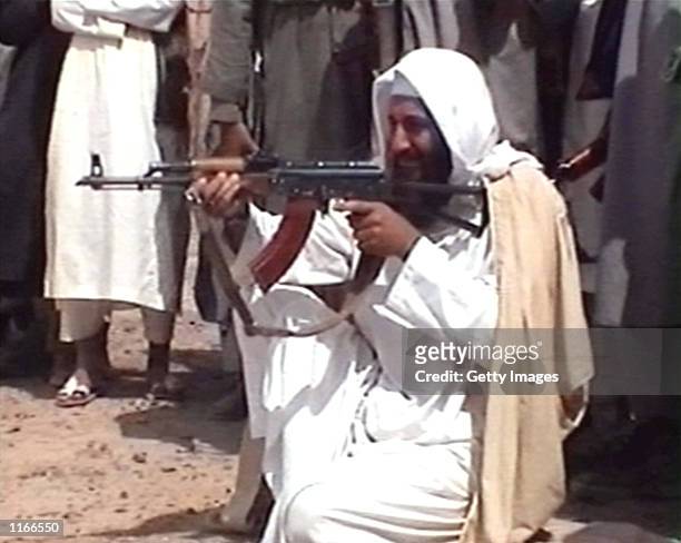 Saudi-born terrorist suspect Osama bin Laden is seen aiming a weapon in this undated photo from Al-Jazeera TV.