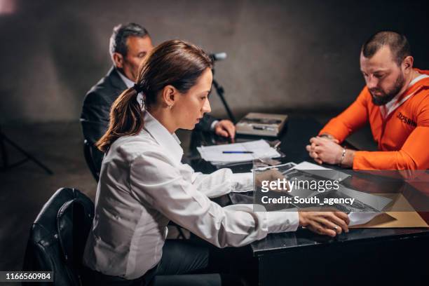 detectives and prisoner in interrogation room - probation stock pictures, royalty-free photos & images