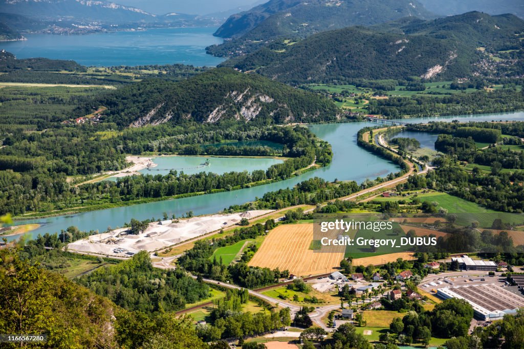 Beautiful aerial view French summer landscape viewed from Grand Colombier summit in middle of Bugey mountains in Ain department, with Rhone river, vibrant green fields and Lake Bourget in Savoie