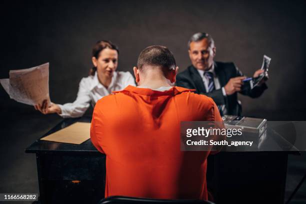 detectives and prisoner in interrogation room - confession law stock pictures, royalty-free photos & images