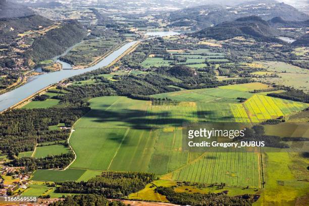 beautiful hilly french landscape aerial view in middle of bugey mountains in ain department near savoie, with rhone river, vibrant green fields and famous lake bourget not far, shot in summer - rhone river stock pictures, royalty-free photos & images