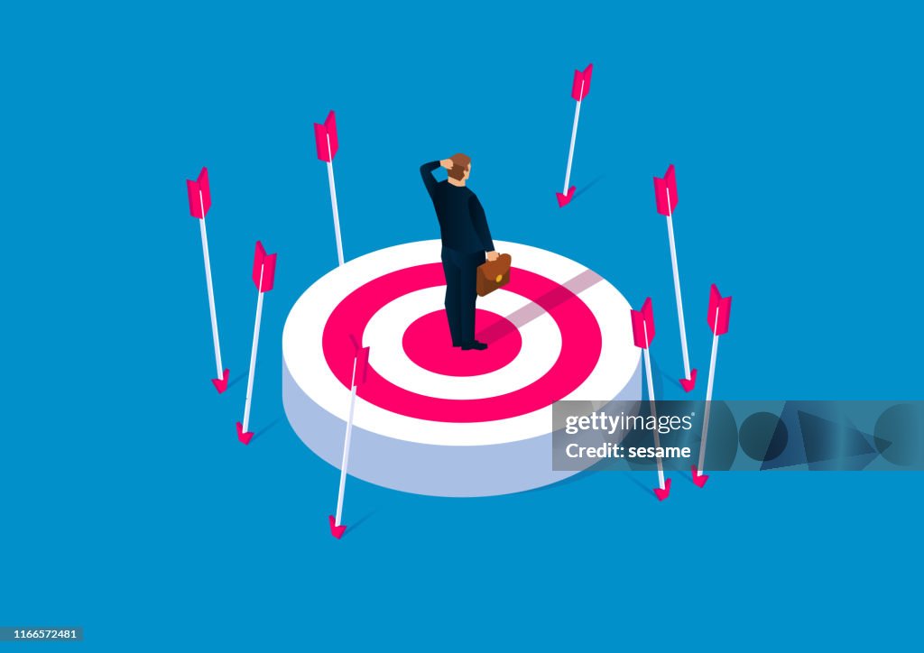 Off-target, failure concept, desperate businessman standing on target without hit