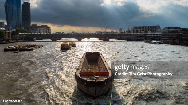 an empty barge being towed on the river thames, london, uk - by the thames stock pictures, royalty-free photos & images