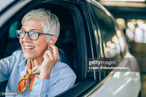 successful businesswoman on the move - in ear headphones stock pictures, royalty-free photos & images