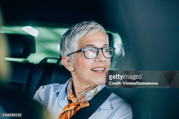 businesswoman on the move - old woman by window stock pictures, royalty-free photos & images