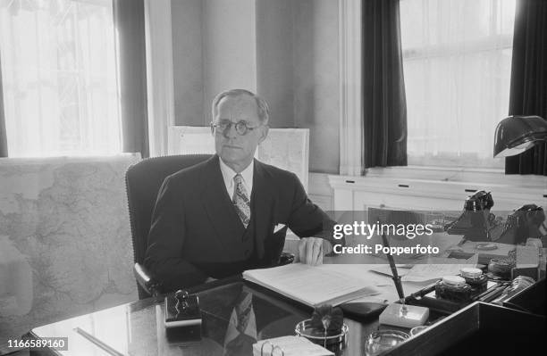 American businessman and politician Joseph P Kennedy Sr , United States Ambassador to the United Kingdom, pictured seated at a desk in his office at...