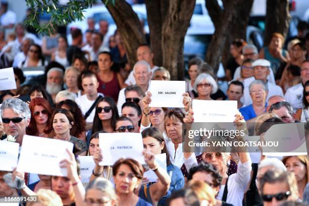 Demonstrators, mostly women, hold signs reading names of victims of femicides preceded with an ordinal number as "100 - Salome", in memory of Salome,...