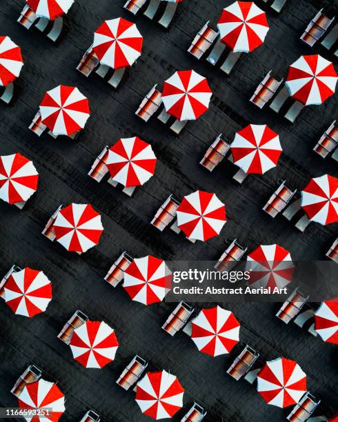 drone image directly above beach umbrellas, massa, italy - massa ストックフォトと画像
