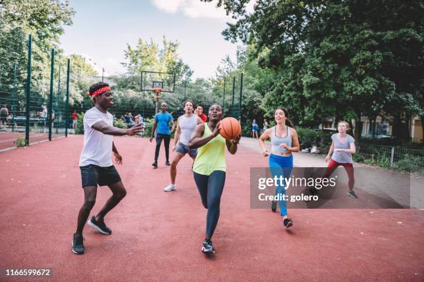 young mixed sports team playing basketball on hardcourt - mixed gender sports stock pictures, royalty-free photos & images