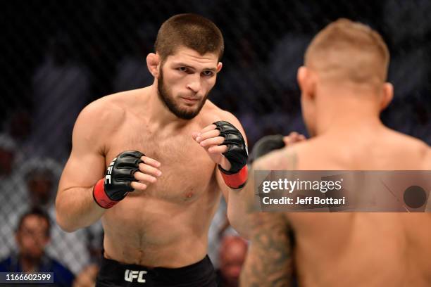 Khabib Nurmagomedov of Russia battles Dustin Poirier in their lightweight championship bout during UFC 242 at The Arena on September 7, 2019 in Yas...