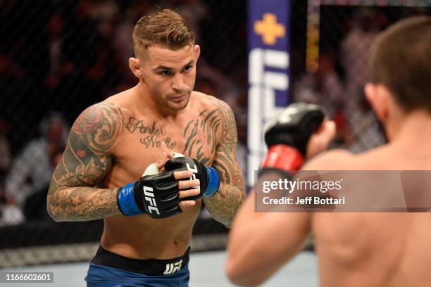 Dustin Poirier battles Khabib Nurmagomedov of Russia in their lightweight championship bout during UFC 242 at The Arena on September 7, 2019 in Yas...