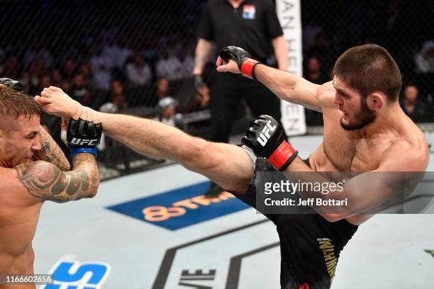 Khabib Nurmagomedov of Russia kicks Dustin Poirier in their lightweight championship bout during UFC 242 at The Arena on September 7, 2019 in Yas...