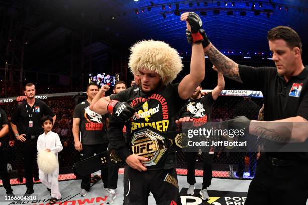 Khabib Nurmagomedov of Russia celebrates his submission victory over Dustin Poirier in their lightweight championship bout during UFC 242 at The...