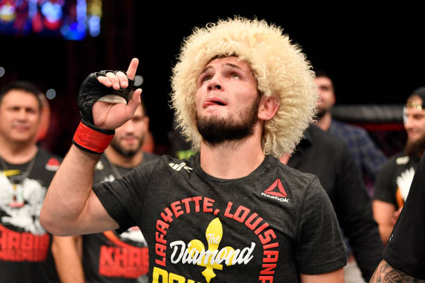 Khabib Nurmagomedov of Russia celebrates his submission victory over Dustin Poirier in their lightweight championship bout during UFC 242 at The...