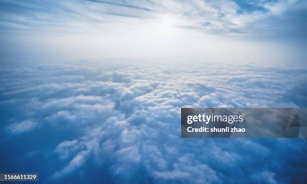scenery above the clouds - flugzeug sonne stock-fotos und bilder