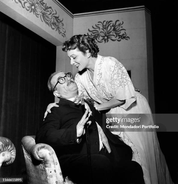 Italian actors Peppino De Filippo and Lidia Martora smiling at each other in the theatre comedy Il dispensatore. Milan, 1954