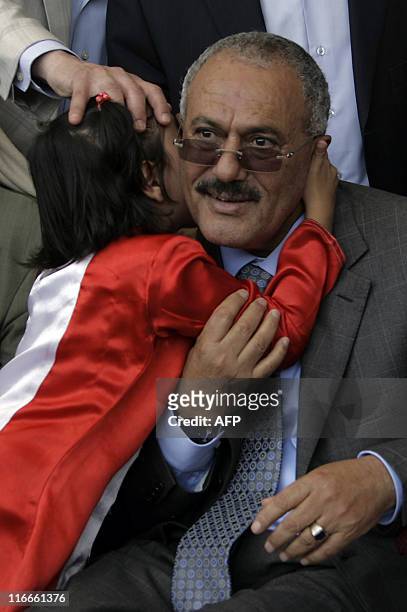 Young girl kisses Yemeni President Ali Abdullah Saleh during a Friday rally in his supporters in Sanaa on May 13, 2011 where he vowed to stay on and...