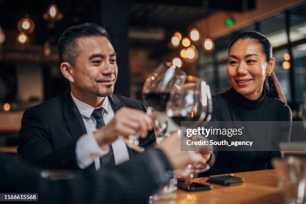 business people drinking red wine in restaurant - honour board stock pictures, royalty-free photos & images
