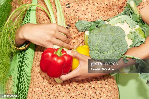 close up of woman holding vegetables - camera flash stock pictures, royalty-free photos & images