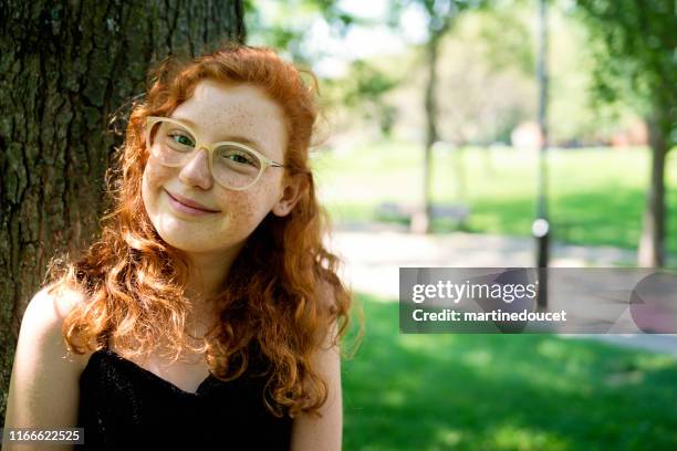 portrait of beautiful teenage girl in a park. - freckle girl stock pictures, royalty-free photos & images