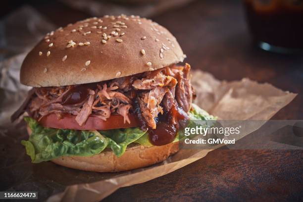pulled pork burger with tomato, salad and barbecue sauce - pulled pork stock pictures, royalty-free photos & images
